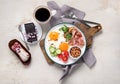 Traditional Englis breakfast plate with bacon strips, sunny side up eggs, vegetables Royalty Free Stock Photo