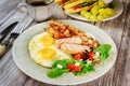 Traditional English breakfast with bacon, eggs, sausages, salad and grilled cheese toast Royalty Free Stock Photo