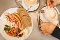 Traditional English breakfast. National food. A famous dish all over the world. Top view. A man drinks coffee and eats. Royalty Free Stock Photo