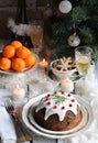 Traditional english Christmas steamed pudding with winter berries, dried fruits, nut in festive setting with Xmas tree, burning ca