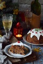 Traditional english Christmas steamed pudding with winter berries, dried fruits, nut in festive setting with Xmas tree, burning ca Royalty Free Stock Photo