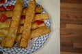 Close up food photography of traditional English homemade cheese straws on a plate with love heart decorations