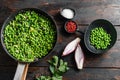 Traditional English Mushy Peas  ingredients for fish and chips in frying pan and peas in bowl with mint shallot pepper and salt Royalty Free Stock Photo