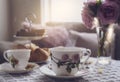 Traditional English tea time, Afternoon tea ceremony with cuppa tea, croissants, crackers and biscuits on hight tea stand in pink