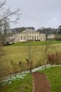 A traditional English 18th century manor house above a footpath in winter