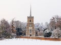 Traditional English village church covered in Snow. Royalty Free Stock Photo