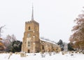 Traditional English village church covered in Snow. Royalty Free Stock Photo