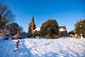 Traditional English village churchyard in snow Royalty Free Stock Photo