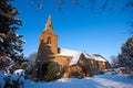 Traditional English village churchyard in snow Royalty Free Stock Photo