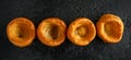 Traditional English Yorkshire pudding side dish on black plate and background Royalty Free Stock Photo