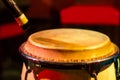 Traditional ethnic Cuban conga drum on red background. Musical instrument made of wood covered with leather and microphone. Ethnic Royalty Free Stock Photo