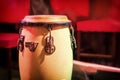 Traditional ethnic Cuban Djembe drum on red background. Percussion instruments made of wood covered with leather. Ethnic drum set Royalty Free Stock Photo