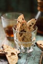 Traditional Europe pastry biscotti or carquinyoli with raisins in glass served with black coffee on old green wooden boards Royalty Free Stock Photo