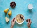 Milk and granola. Traditional european breakfast. Muesli, dates and fresh pears