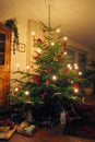 Traditional European Christmas Tree with Candles Burning and Presents