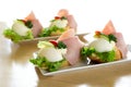 Traditional European open egg and ham sandwiches on white ceramic plates.