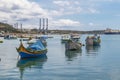 The traditional eyed boats in the harbor of fishing village Marsaxlokk in Malta Royalty Free Stock Photo