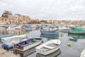 Traditional eyed colorful boats Luzzu in the Harbor of Mediterranean fishing village Marsaxlokk, Malta Royalty Free Stock Photo