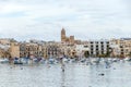 Traditional eyed colorful boats Luzzu in the Harbor of Mediterranean fishing village Marsaxlokk, Malta Royalty Free Stock Photo