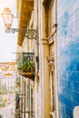 Traditional facade front of portuguese buildings with balconys and lamps. Old charming street in Lisbon , Portugal Royalty Free Stock Photo