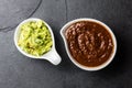 Traditional famous mexican sauces chocolate chili mole poblano, and avocado guacamole on slate gray background