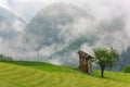 Traditional farming, hayrack in meadow with low clouds in Sloven Royalty Free Stock Photo