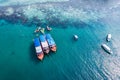 Traditional ferry anchored and tourist snorkeling and enjoying with coral reef in tropical sea