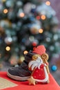 Traditional festive holiday boots filled with treats and Saint Nicholas cookies on bokeh background. Classical holiday Royalty Free Stock Photo