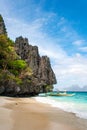Banca boat on the white sand pristine beach of Entalula island in El nido, region of Palawan in the Philippines. Vertical view Royalty Free Stock Photo