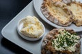 Traditional Finnish foods - Fresh Karelian pies with rice pudding filling and egg butter and chives topping against black Royalty Free Stock Photo