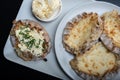 Traditional Finnish foods - Fresh Karelian pies with rice pudding filling and egg butter and chives topping against black Royalty Free Stock Photo