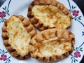 Traditional Finnish Karelian pies on a plate with black background.