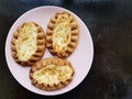 Traditional Finnish Karelian pies on a plate with black background.