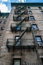 Traditional fire escape ladders at the facade of a New York`s apartment Royalty Free Stock Photo
