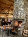 Traditional fireplace with burning firewood and decorations in modern restaurant interior