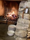 Traditional fireplace with burning firewood and decorations in modern restaurant interior