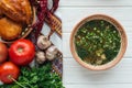 traditional fish soup with green onion, embroidered towel, mini pies and ingredients