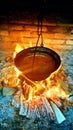 Traditional fish soup with paprika in a cauldron and over low heat