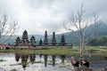 Traditional fisher boat and Balinese temple on Danau Tamblingan lake Royalty Free Stock Photo