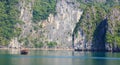 Traditional fisherman boat and seascape on water and island background, Ha Long Bay, Vietnam Royalty Free Stock Photo