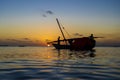 Fisherman dhow boat during sunset on Indian ocean in island Zanzibar, Tanzania, East Africa Royalty Free Stock Photo