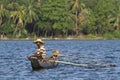 Traditional fisherman in dugout canoe in Sri Lanka