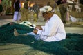 A traditional Omani fisherman is weaving a fishing net at Muscat Festival