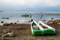 Traditional fishermen canoes at the coast along lake Atitlan with man fishing during sunset in San Pedro la Laguna, Guatemala Royalty Free Stock Photo