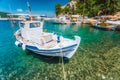 Traditional fishing boat in crystal clear Mediterranean sea cove of Ithaka island, Greece Royalty Free Stock Photo