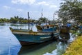 A traditional fishing boat rests on the banks of the lagoon in Negombo, Sri Lanka Royalty Free Stock Photo