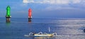 Traditional fishing boat on sanur beach bali with green and red lighthouse tower Royalty Free Stock Photo