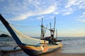 Traditional fishing boat of Sri Lankan fishermen moored on the beach of ocean Royalty Free Stock Photo