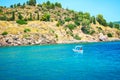 Traditional fishing boat in turquoise water of Aegean Sea on the coast of Greece. Royalty Free Stock Photo