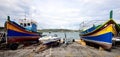 Traditional fishing boats and a modern speedboat on the slipway